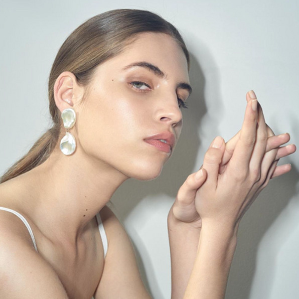 Model wears Meadowlark earrings with hair styled by Chop